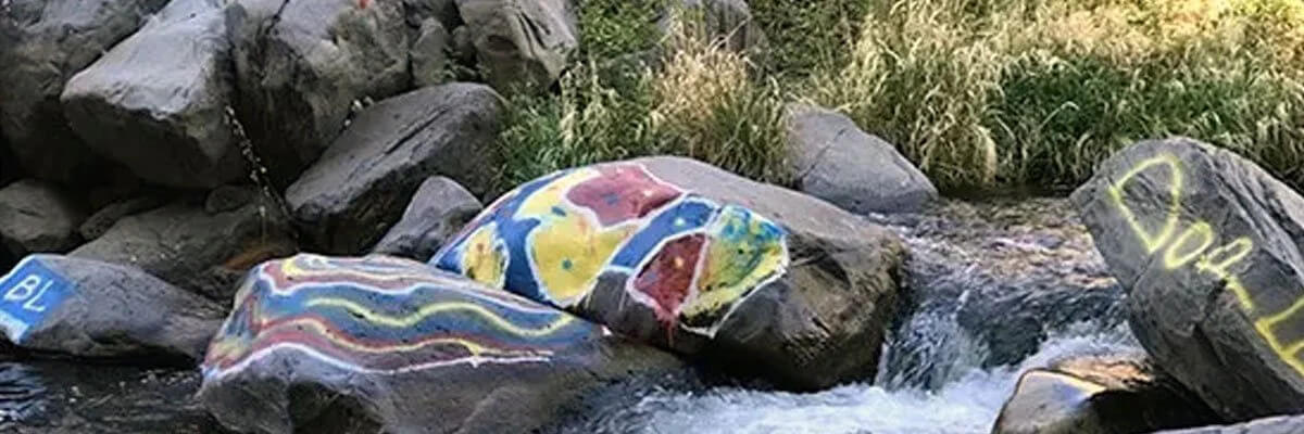 How to remove graffiti from concrete dam walls or stones and boulders near streams or rivers